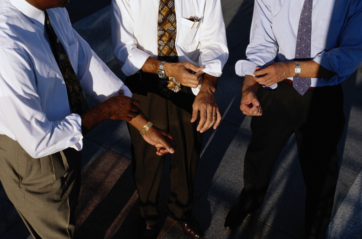 Businessmen Rolling up Their Sleeves